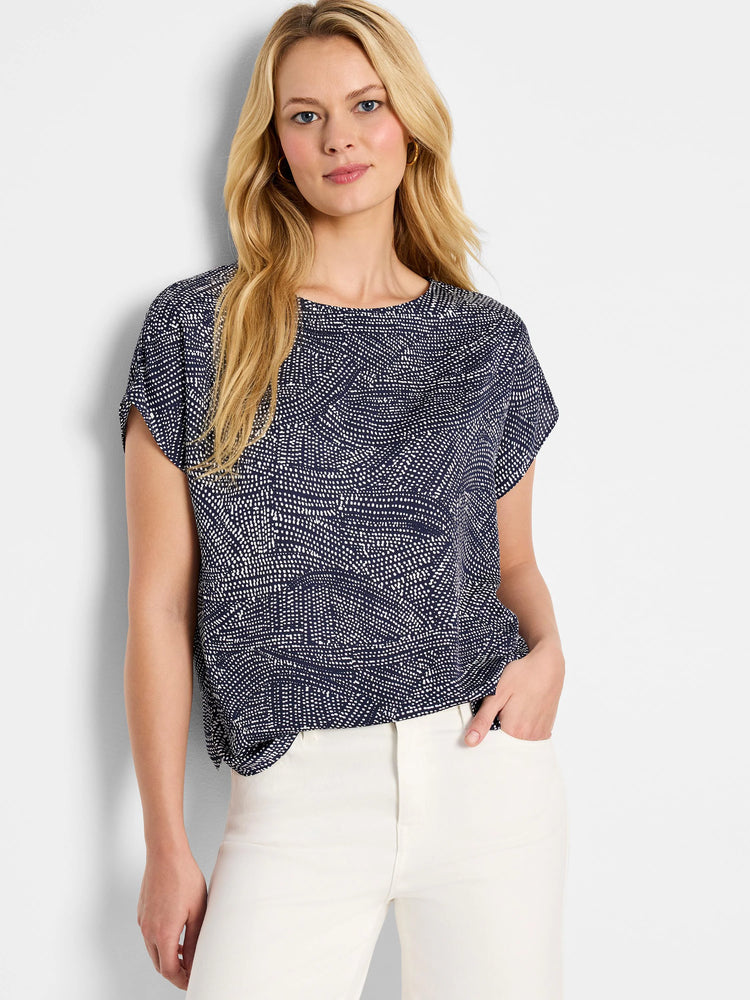 Navy blue short-sleeved top with a white, swirling dot pattern.  Crew neck.
