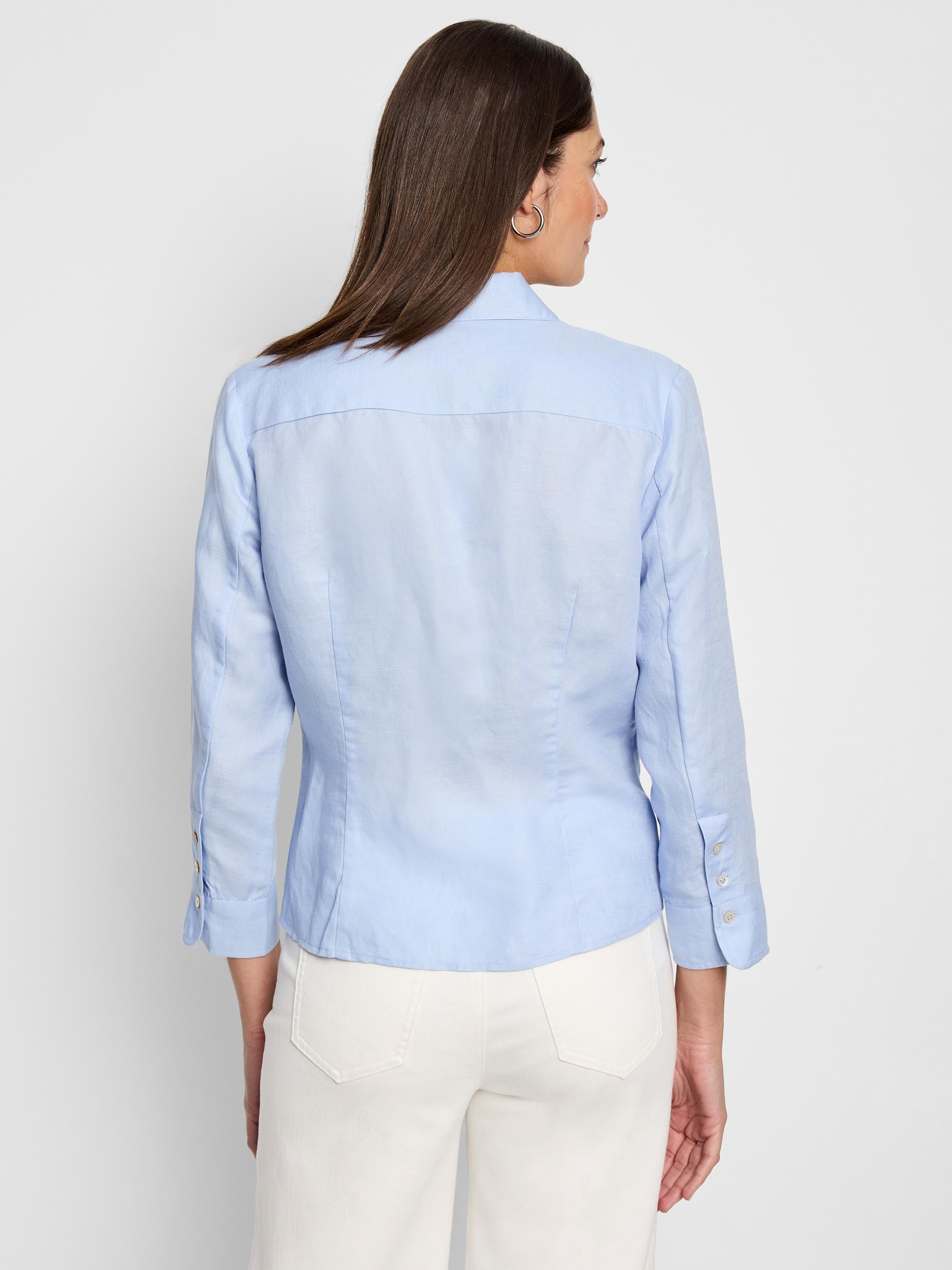 Light blue, three-quarter sleeve shirt;  tie front detail; button cuffs; shown from the back.