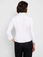 White, long-sleeve collared shirt; tie-front detail; shown from the back.