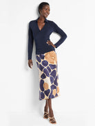Midi slip skirt with an abstract print in beige, dark blue, and light brown.
