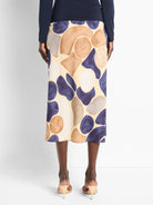 Mid-length slip skirt in beige with abstract purple, brown, and gray shapes.