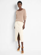 Off-white denim midi skirt with a front slit.  Features visible seams.