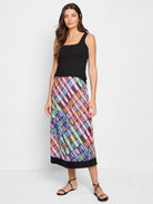 Midi skirt, diagonal rainbow pattern on dark background.  Pink, orange, teal, green accents. Black hem.
