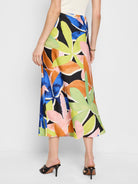 Midi slip skirt; black background, orange, pink, blue, and green abstract floral print.