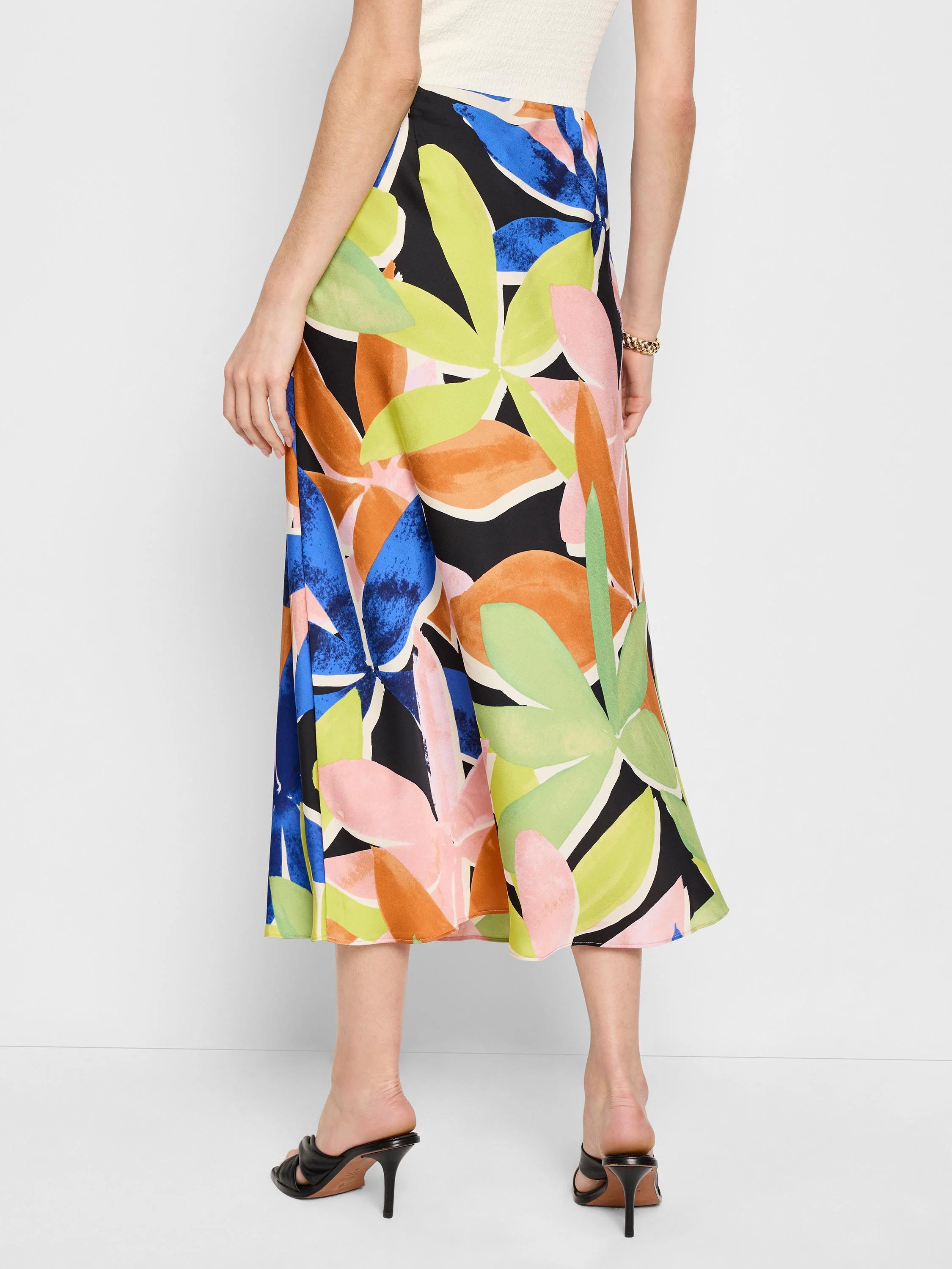 Midi slip skirt; black background, orange, pink, blue, and green abstract floral print.