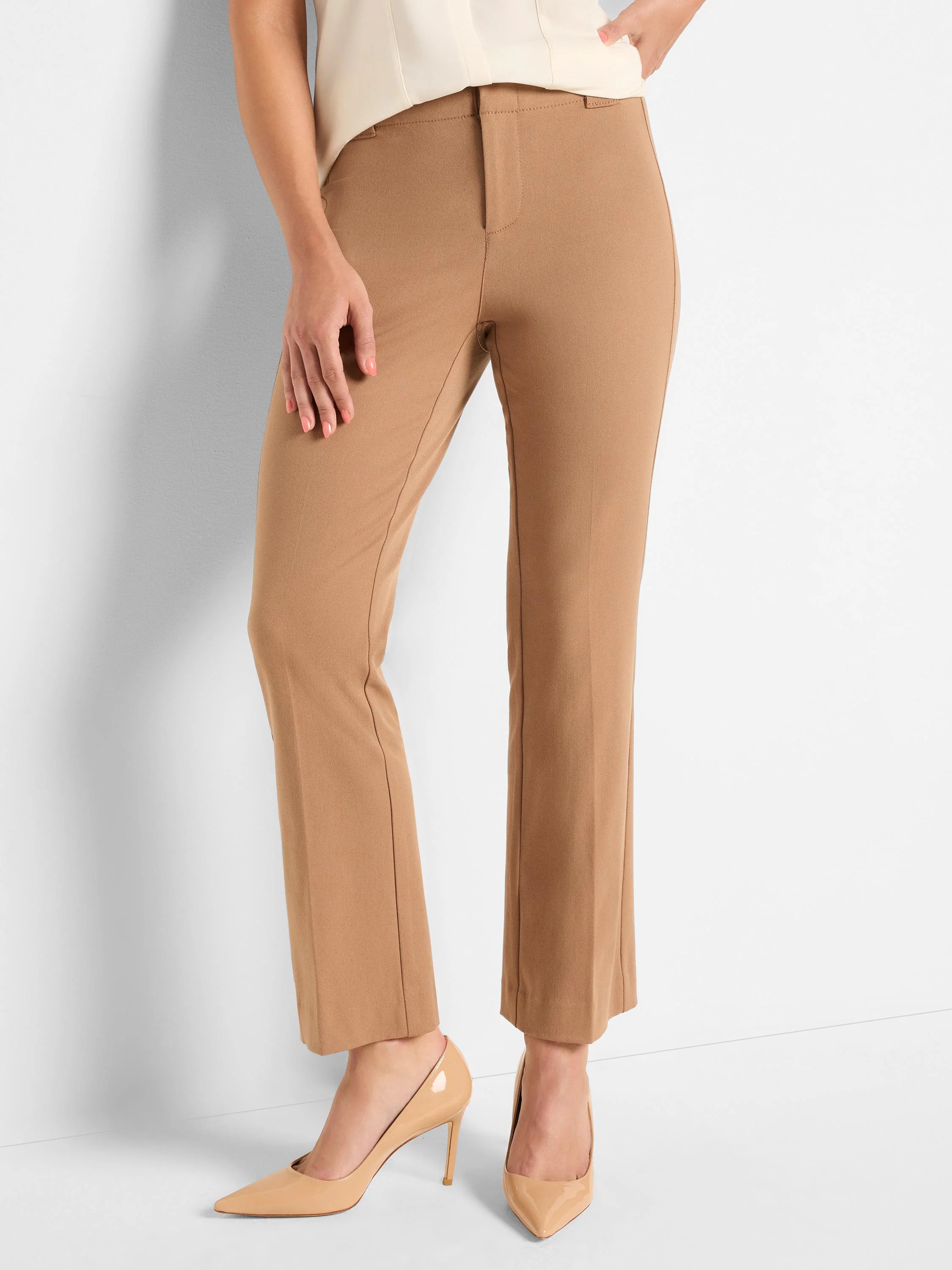 Model wearing tan tailored pants with a flat front, fitted waist, and a slight boot cut at the ankle.