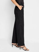 Black linen-cotton wide-leg pants shown on model.  Side view.