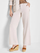 Off-white wide-leg linen-cotton pants shown on a model.
