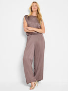 Mauve wide-leg pants with a glossy sheen; sleeveless top with a boat neck.