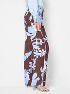 Brown wide-leg pants with a light blue floral print and subtle side stripe.