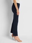 Navy straight-leg pants on a model, featuring a tailored waist and a flat back pocket.