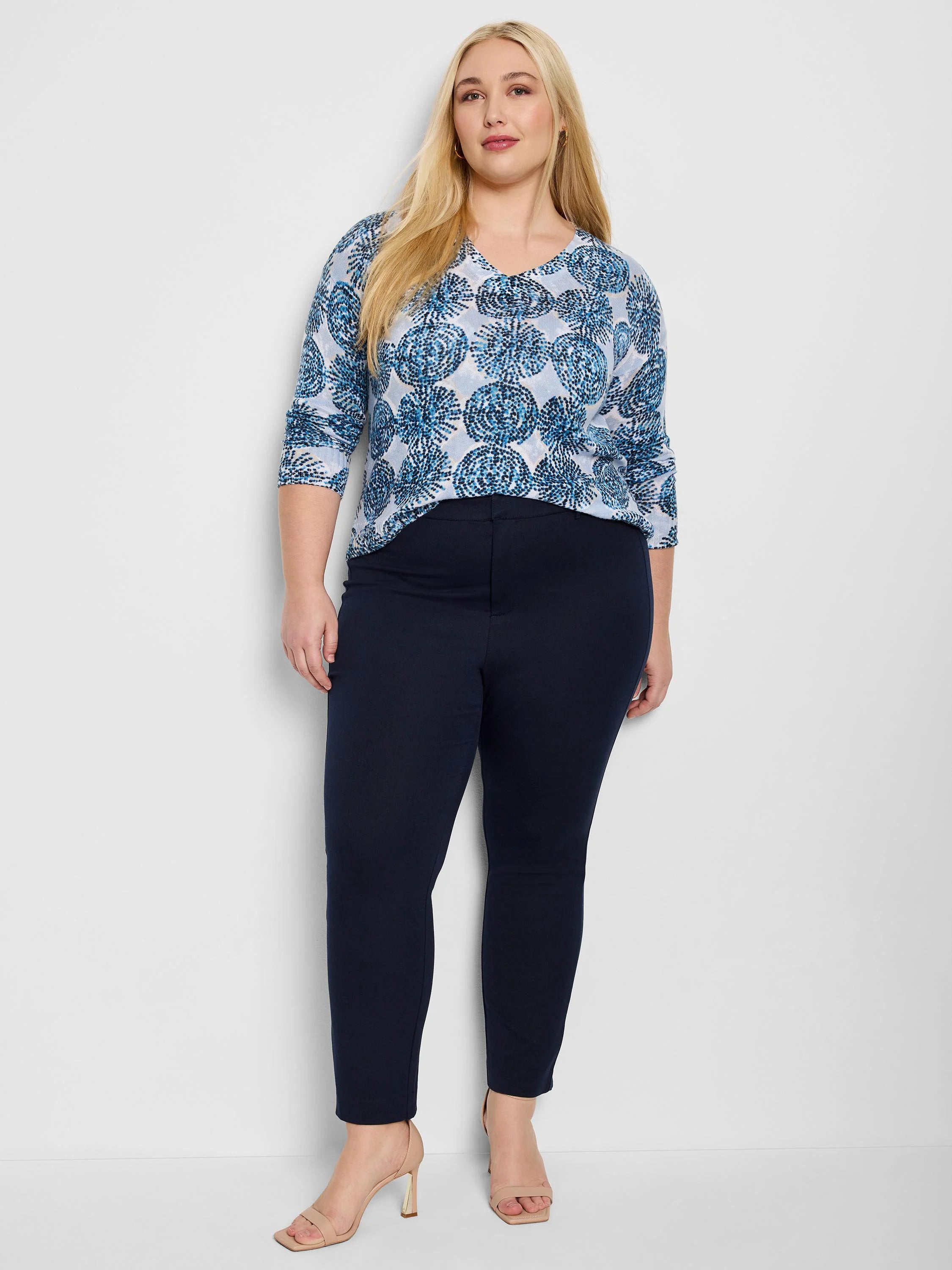 Dark navy straight-leg pants on model. Smooth, flat front; ankle length.