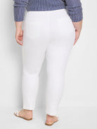 White straight-leg pants, rear view. Two patch pockets on back. Appears ankle-length.
