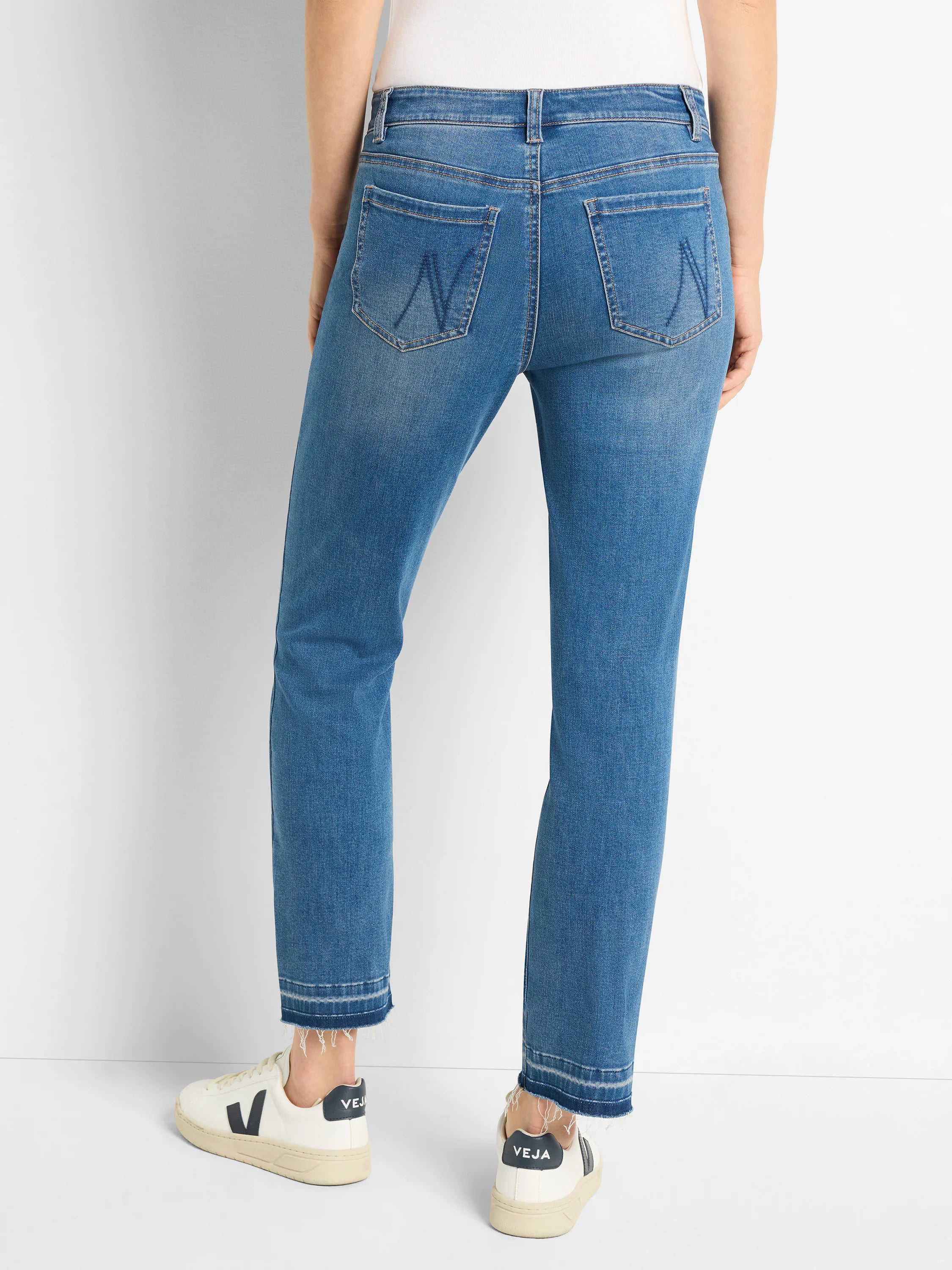 Medium blue straight leg jeans, shown from back. Features frayed, released hems and subtle stitching on back pockets.