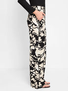 Black wide-leg pants with a beige abstract print.  Side view shows a center front seam and pockets.