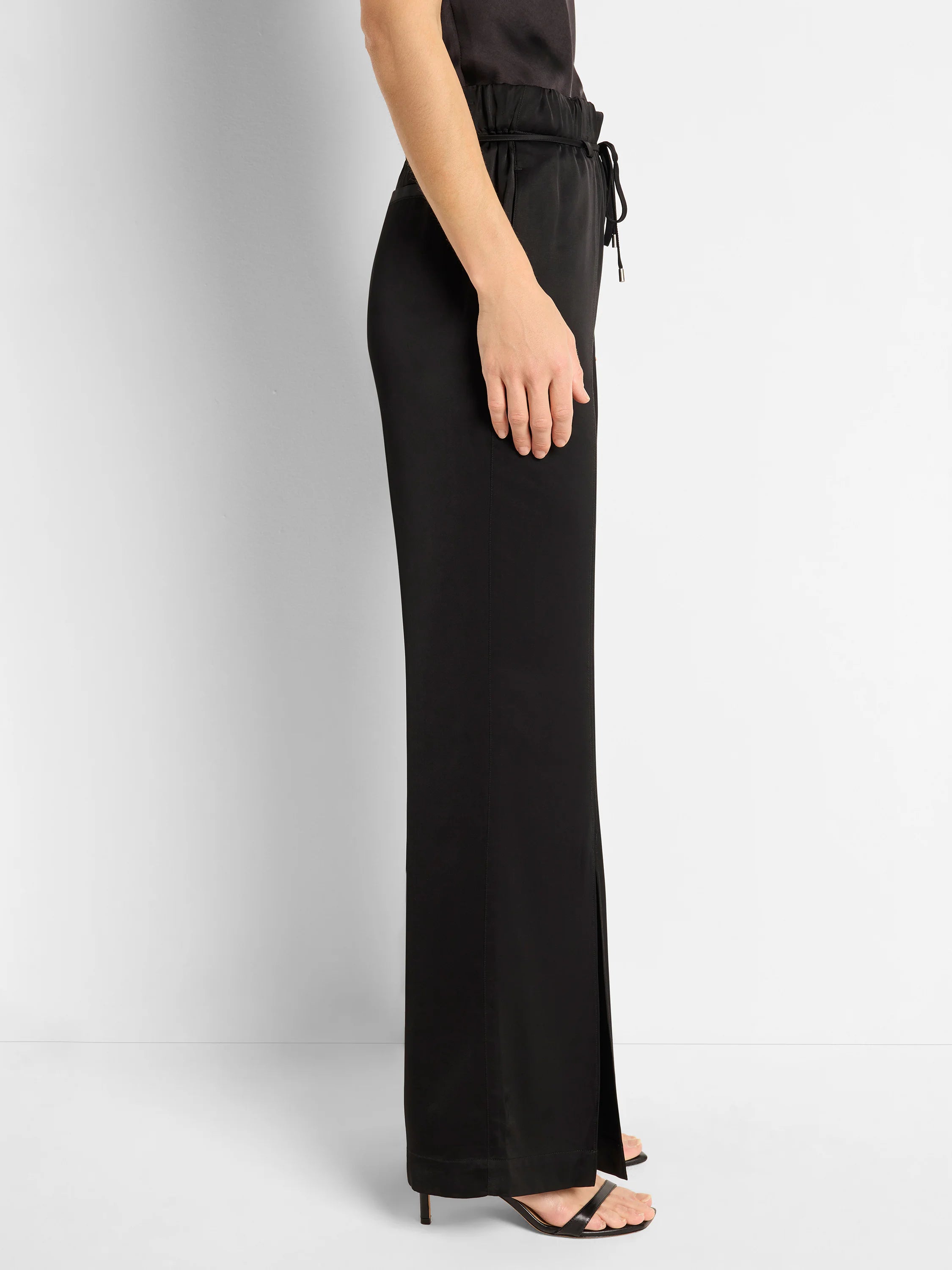 Black satin pants with front slit, elastic waistband, and drawstring.