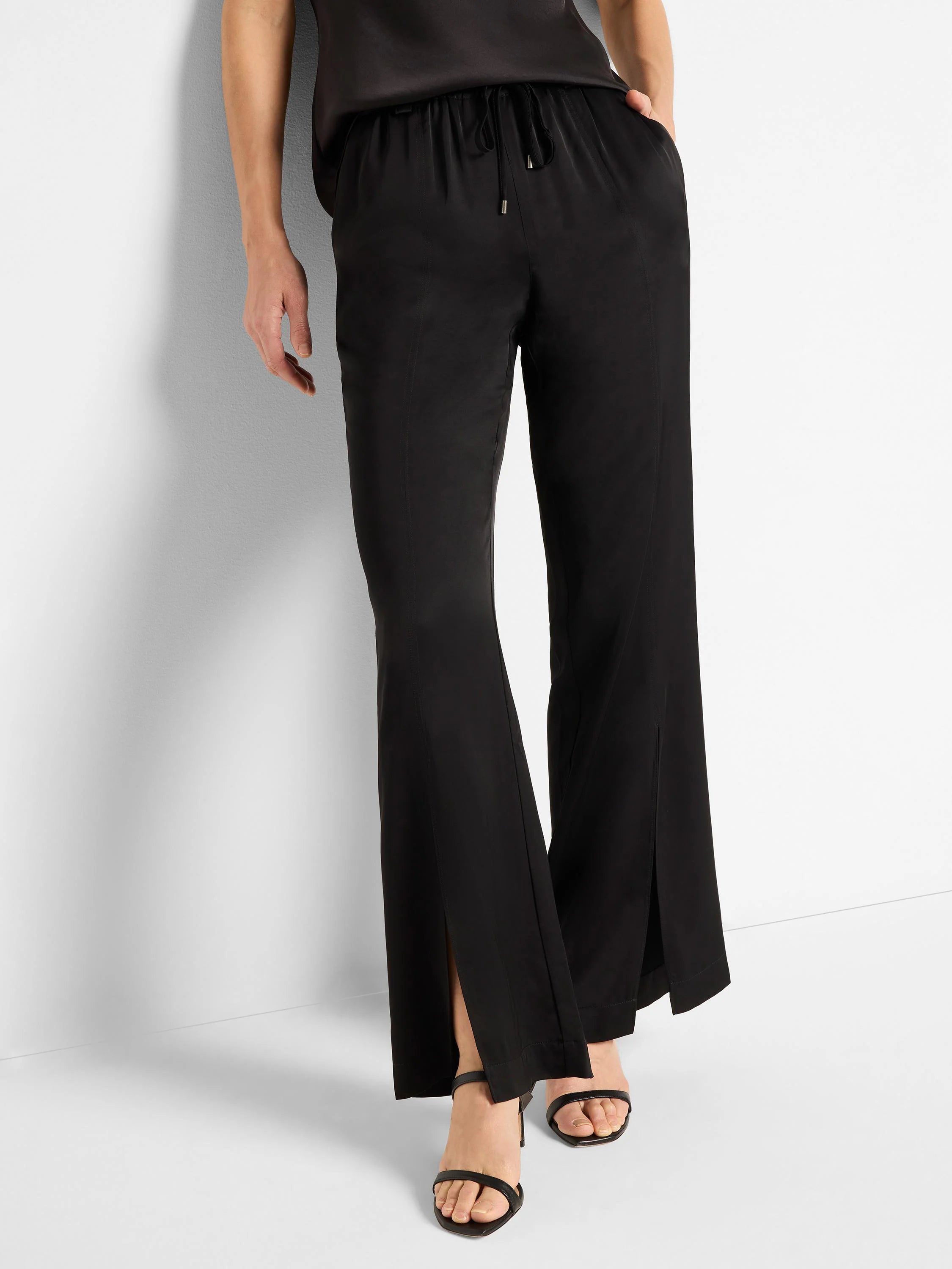 Black satin pants with front slits and drawstring waist.