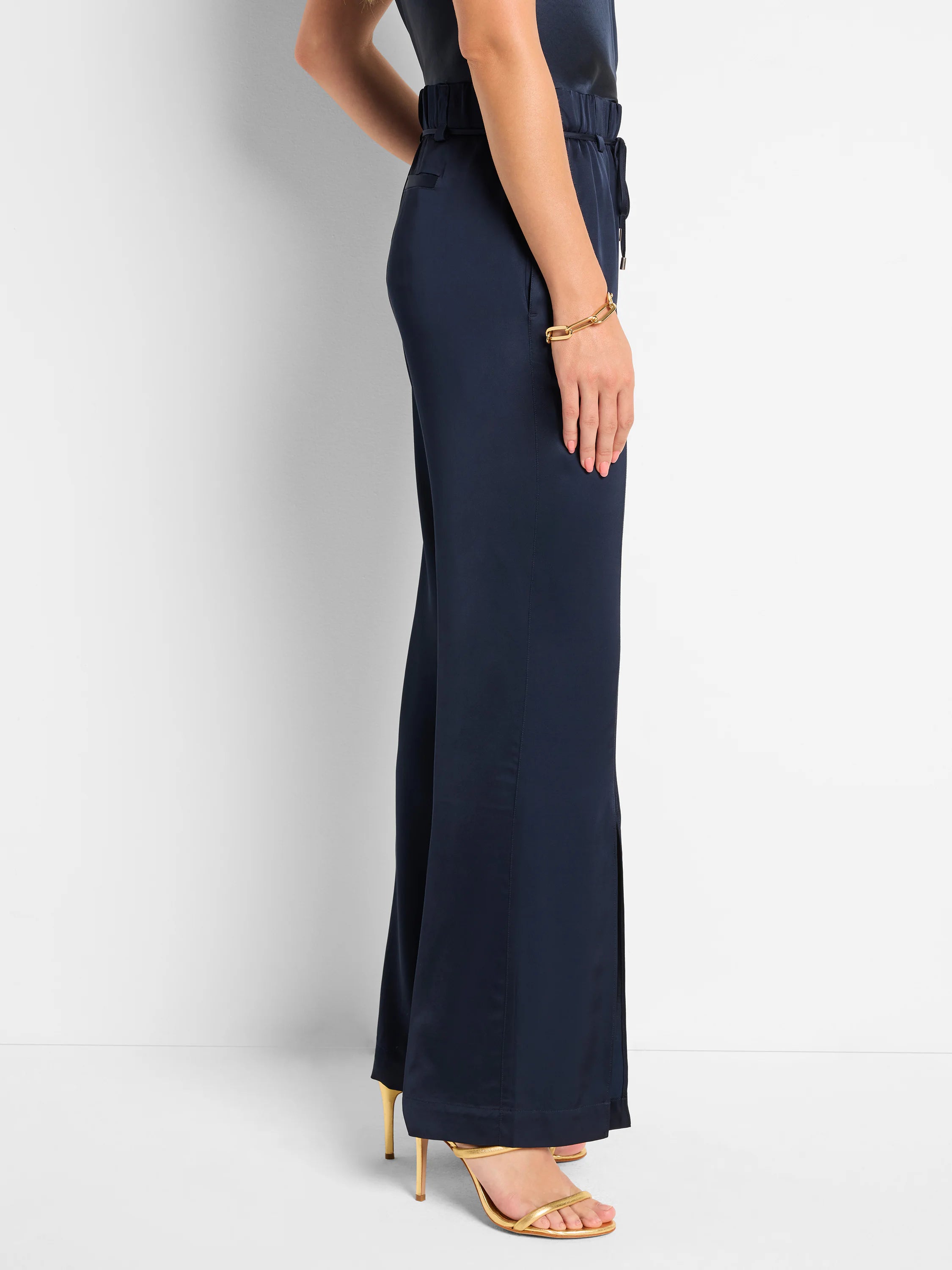 Dark navy blue wide-leg pants with front slits and an elastic waistband.