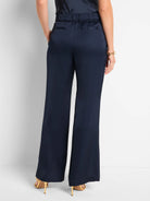 Navy blue wide-leg pants with a drawstring waist and front slit.  Back view shown.