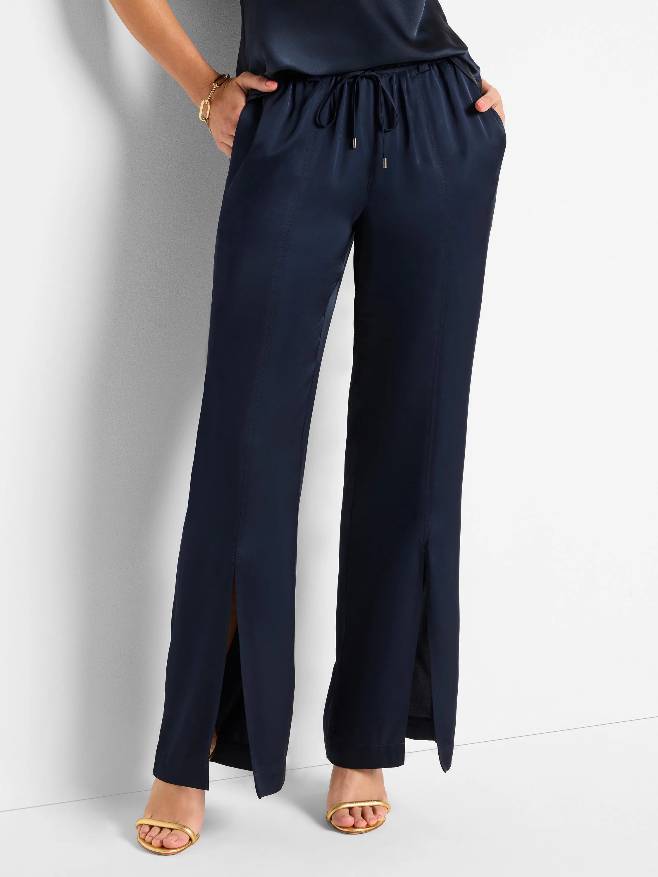 Dark navy blue satin pants with front slits and drawstring waist.