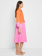 Ombre shirt dress; top half orange, bottom half hot pink.  Three-quarter sleeves, knee-length, belted waist.