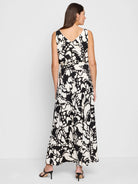 Black and off-white sleeveless maxi dress with an abstract print and a self-tie belt.  The dress has a V-neck.