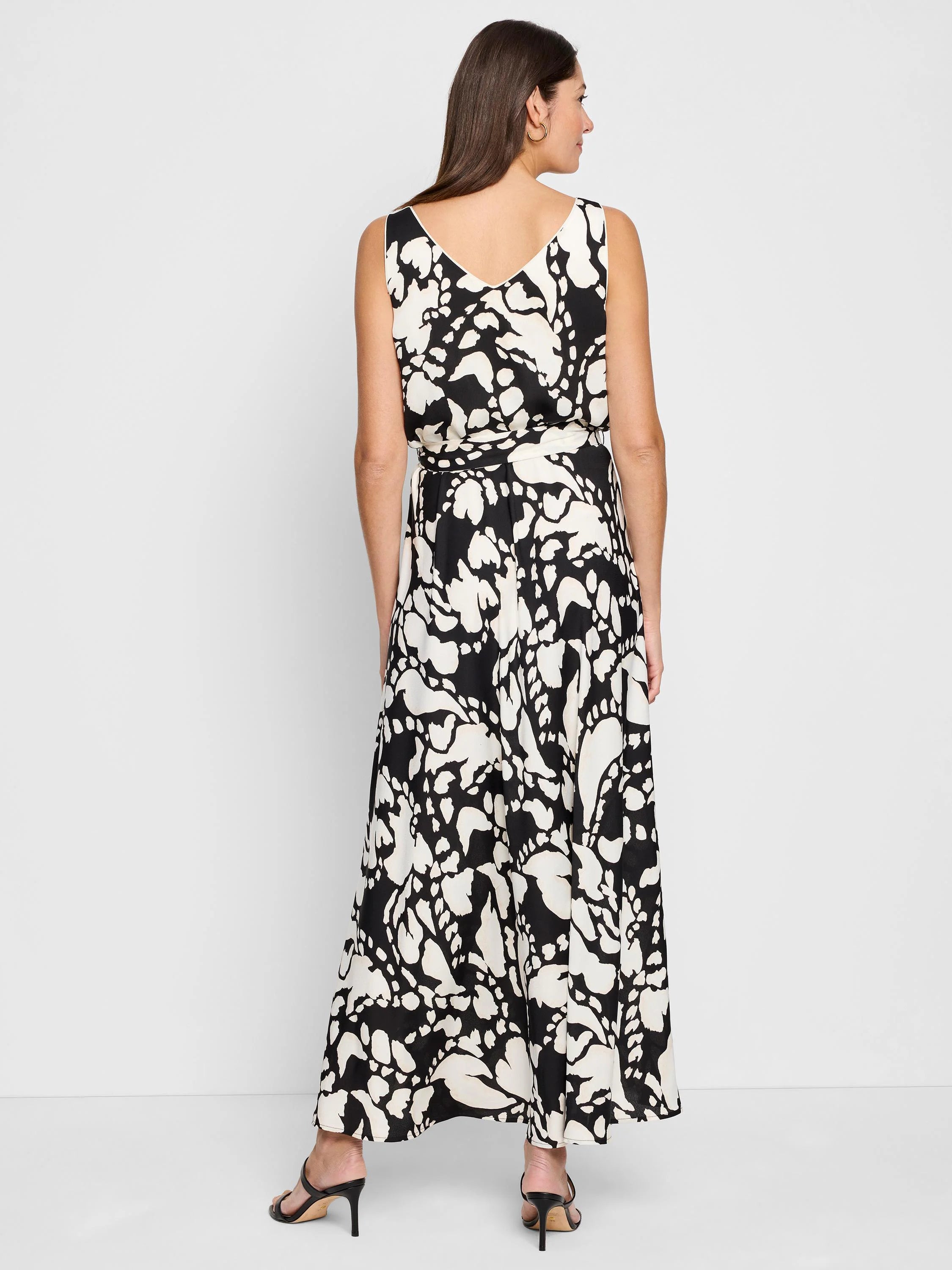 Black and off-white sleeveless maxi dress with an abstract print and a self-tie belt.  The dress has a V-neck.