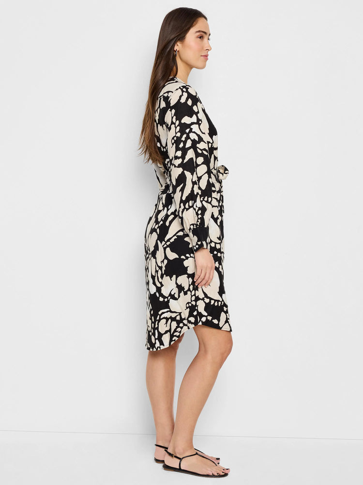 Black midi shirt dress with beige abstract print, belted waist, and long sleeves.