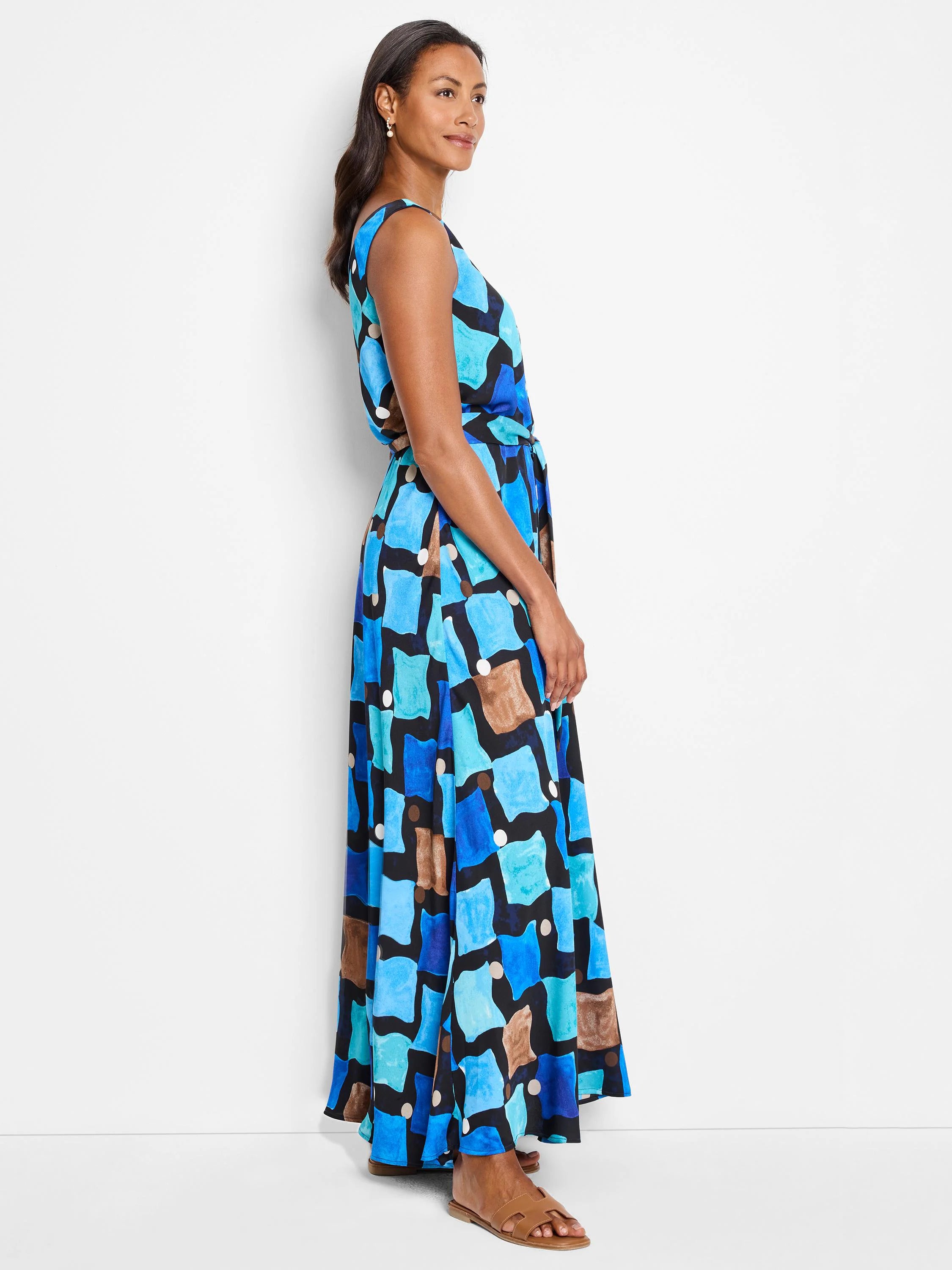 Maxi dress, sleeveless, belted waist. Blue, teal, brown, & black abstract print on dark background.