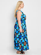 Sleeveless maxi dress;  blue, teal, brown, & white abstract print on black background.
