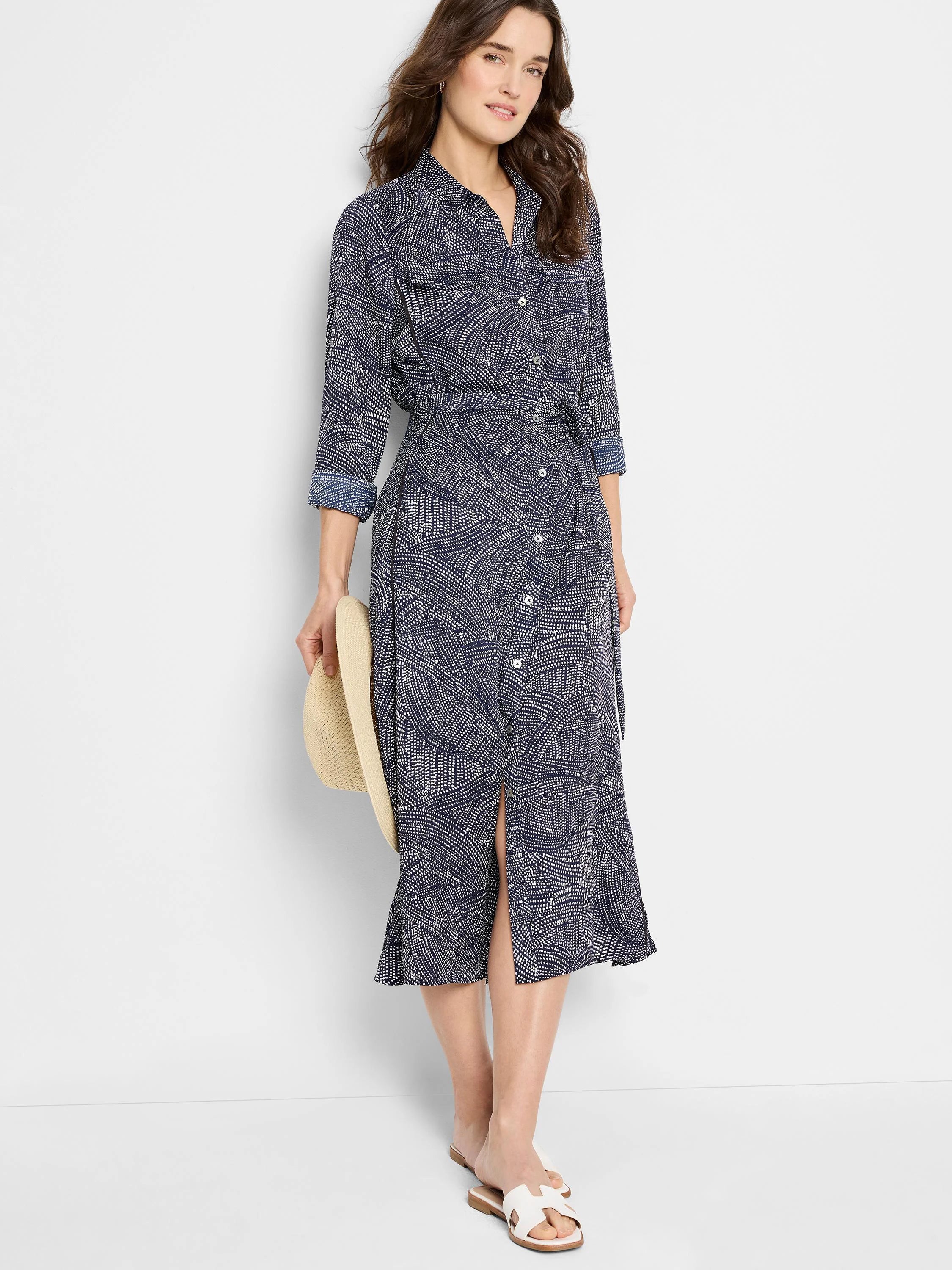 Navy midi shirt dress with a white abstract print, belted waist, and three-quarter sleeves.