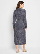 Navy midi shirt dress with a white swirling pattern.  Long sleeves, collared neckline.