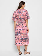 Midi dress, pink, navy, and coral circular pattern, puff sleeves, fitted waist.