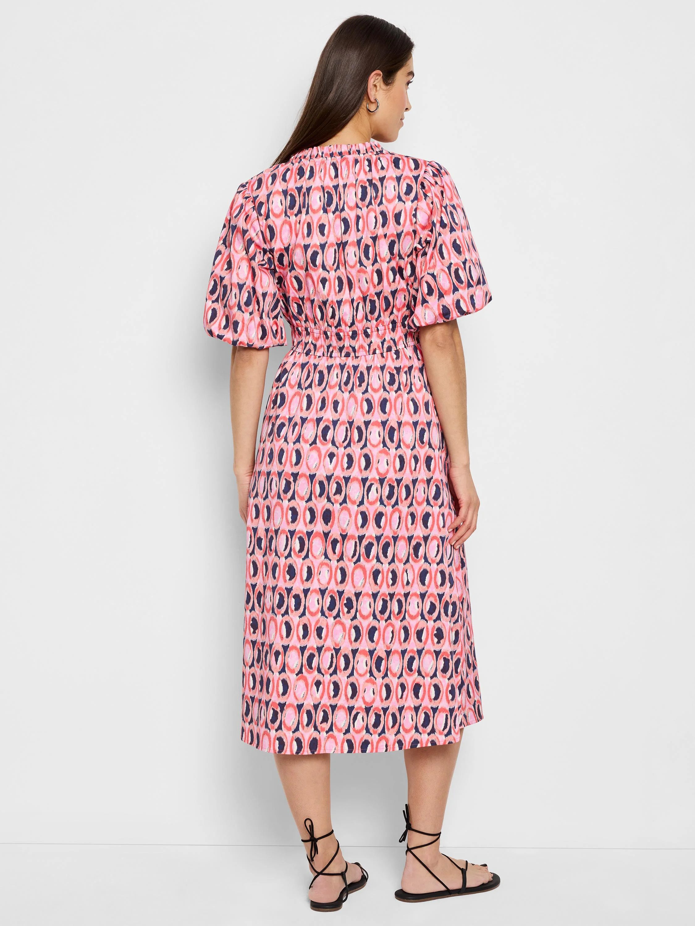 Midi dress, pink, navy, and coral circular pattern, puff sleeves, fitted waist.