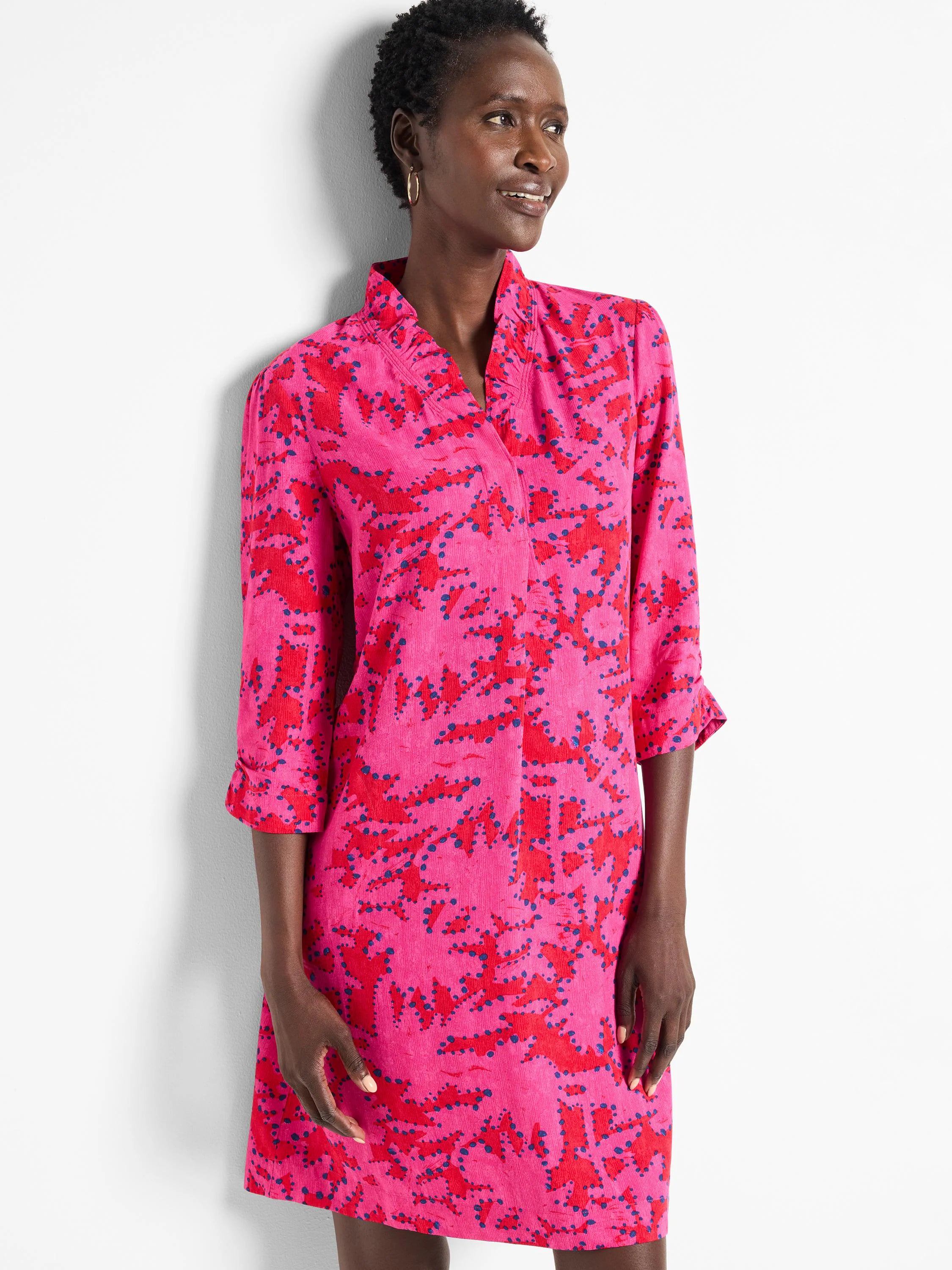 Pink dress with red and dark blue abstract print.  Three-quarter sleeves, ruffled collar.