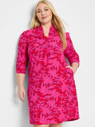 Pink dress with red and dark blue abstract print, 3/4 sleeves, and pockets.