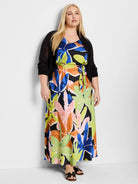 Maxi dress with black background, blue, orange, pink & green abstract floral print.  Features a V-neck and waist tie. ...