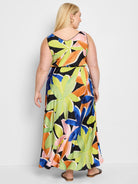 Black sleeveless maxi dress with lime green, orange, pink & blue abstract floral print.