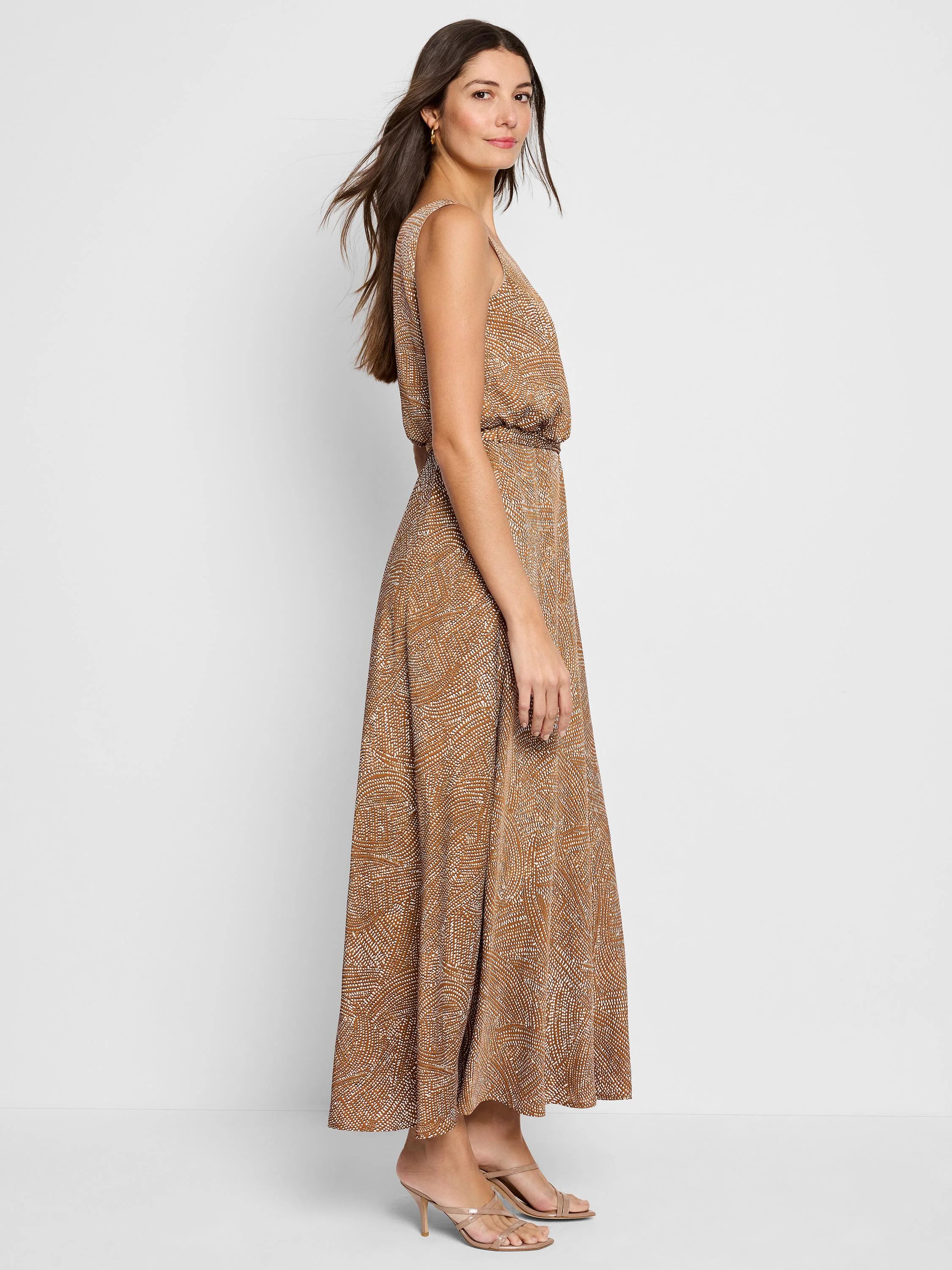 Brown maxi dress with a white abstract print. Sleeveless, fitted bodice, and an A-line skirt.