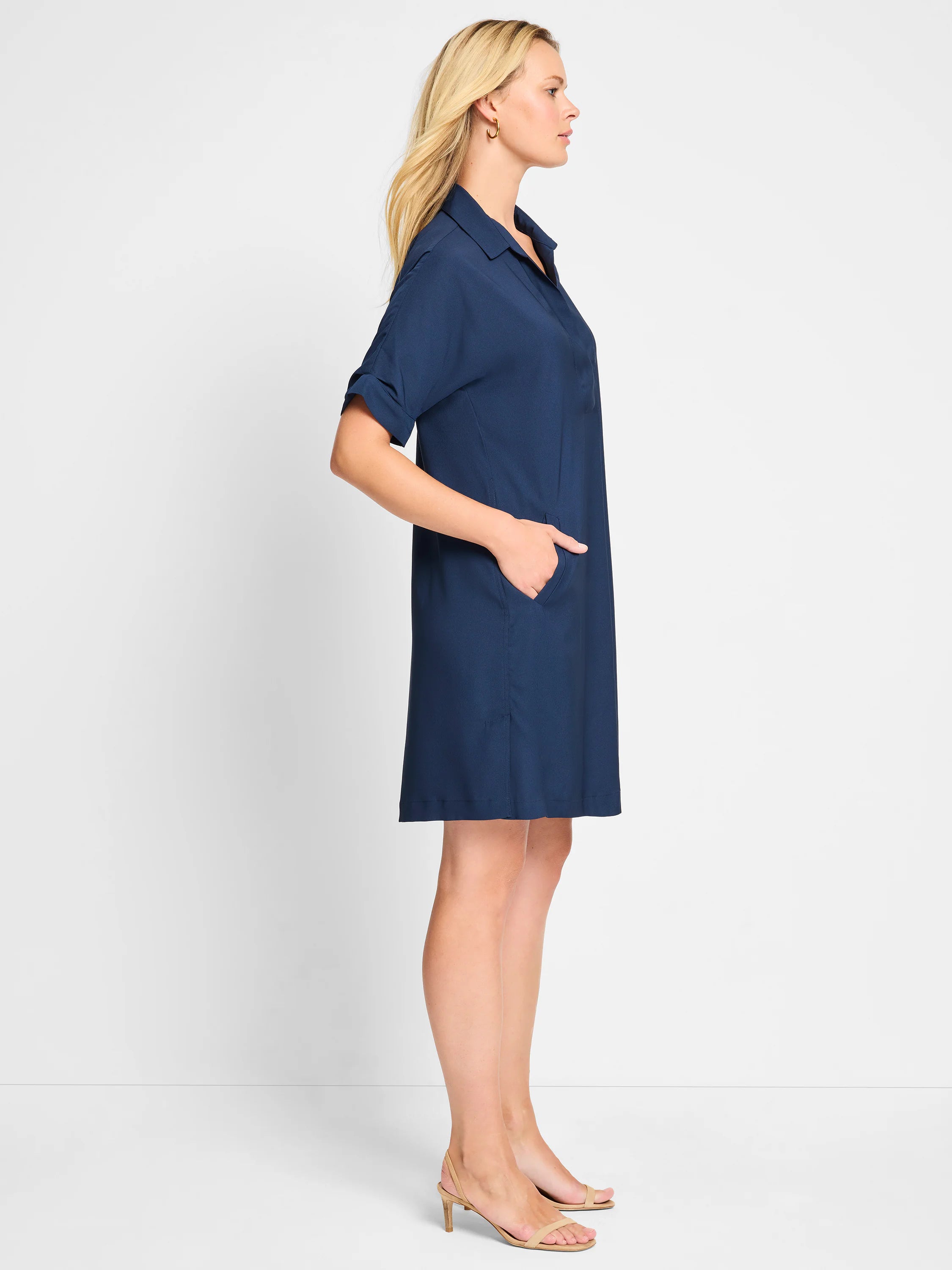 Navy blue collared shirt dress with cuffed short sleeves, straight fit, above-knee length, and side pockets.