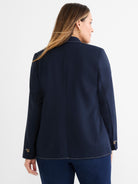 This dark navy tailored blazer has contrast white topstitching along the hem and cuffs with decorative buttons.