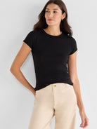 This slim black ribbed tee has contrast beige trim at the crew neck and rolled short sleeves.