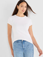 Fitted white ribbed tee has a crewneck and short sleeves finished with subtle contrast tan trim.