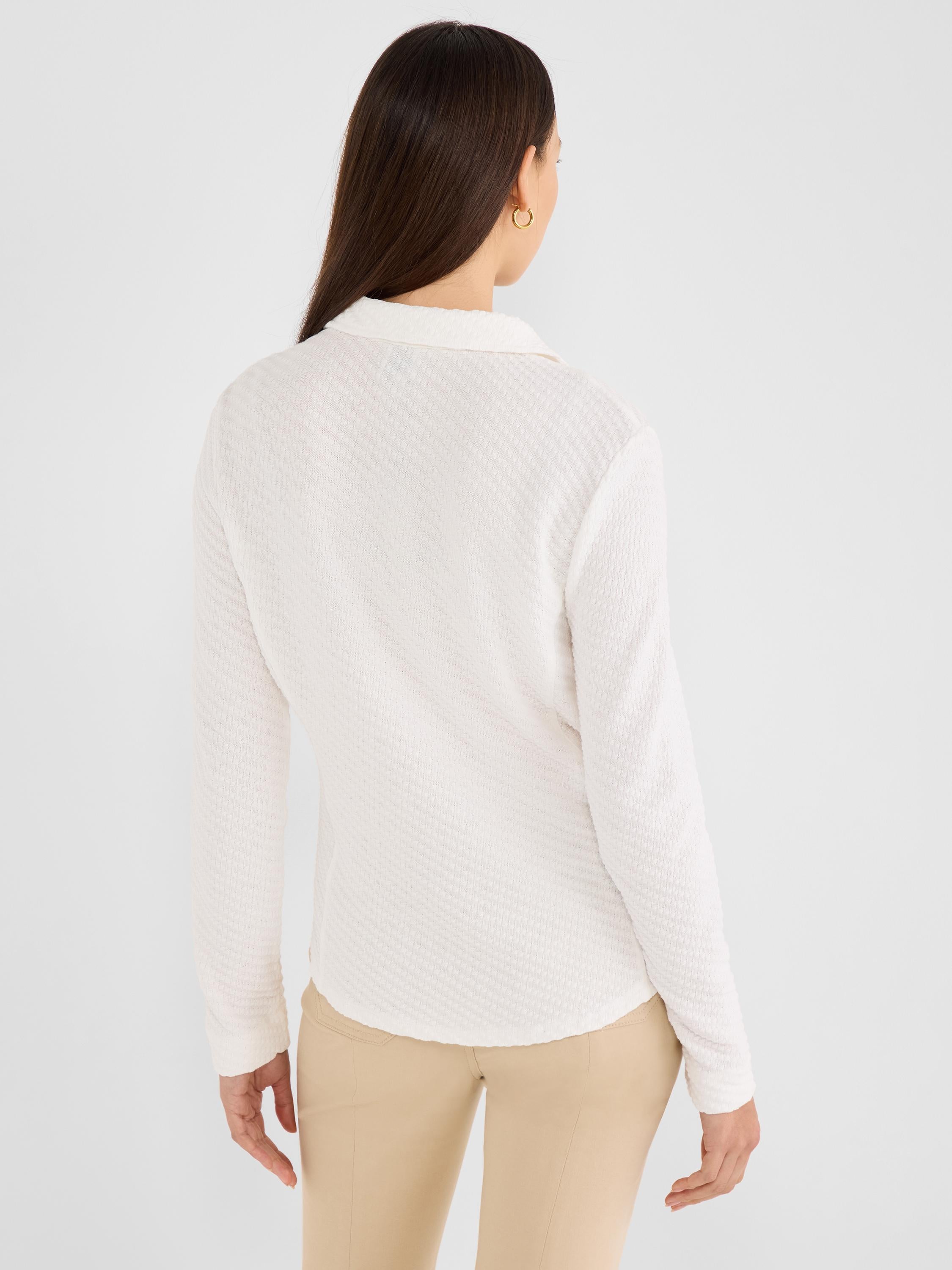 Model wears a slim off-white textured knit long-sleeve collared shirt.