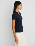 Navy ribbed knit short sleeve polo with collar and button placket.