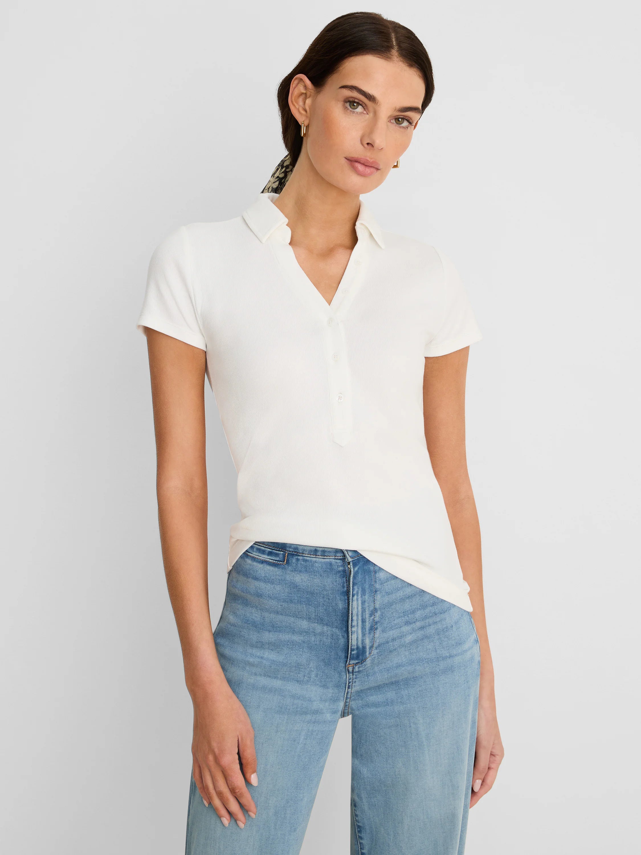 Cream ribbed short sleeve polo with collar and button placket.