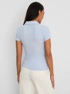Light blue ribbed knit short sleeve polo with a collar.