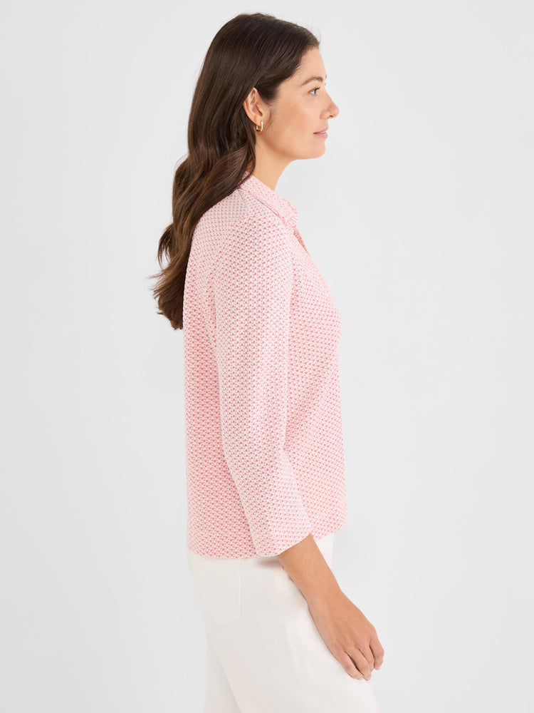 A pink and white textured knit polo top features a standard fit and three-quarter sleeves.