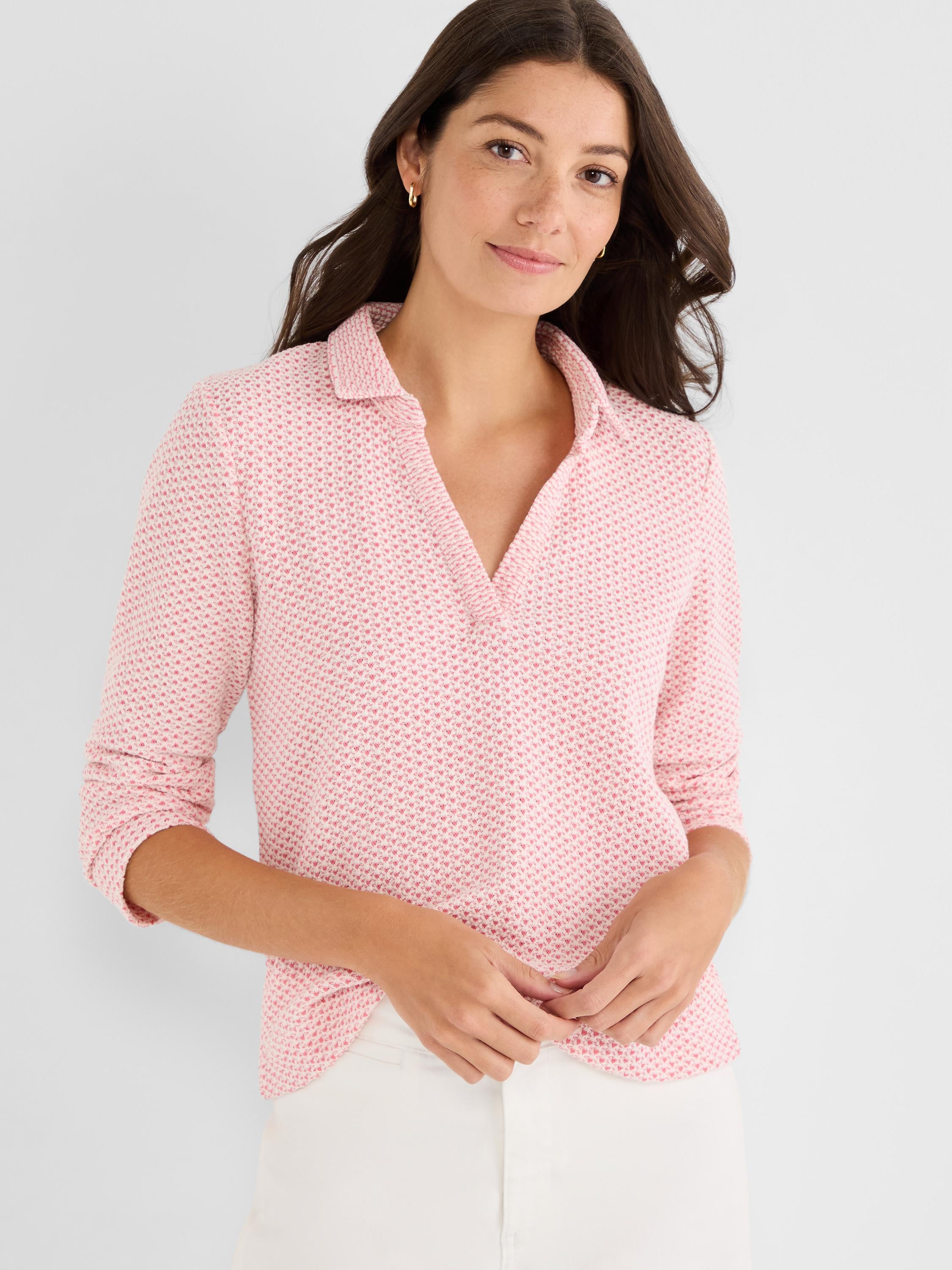 Model wears a pink and white textured knit polo top with a collared V-neck and three-quarter sleeves.