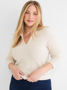 Cream waffle knit sweater features a standard fit and a modern open polo V-neck.